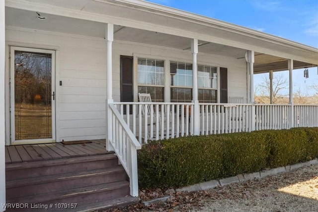 view of exterior entry with a porch