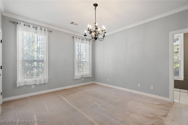 empty room featuring carpet, a notable chandelier, and ornamental molding