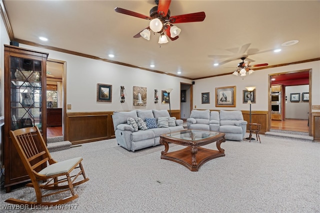 carpeted living room featuring ceiling fan and ornamental molding