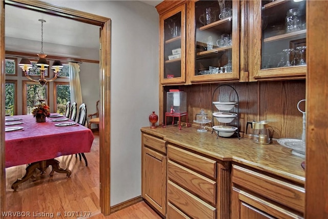 kitchen with hanging light fixtures, a notable chandelier, and light hardwood / wood-style floors