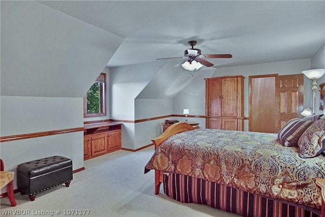 carpeted bedroom with vaulted ceiling and ceiling fan