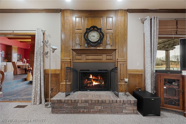 living room featuring a brick fireplace and carpet flooring