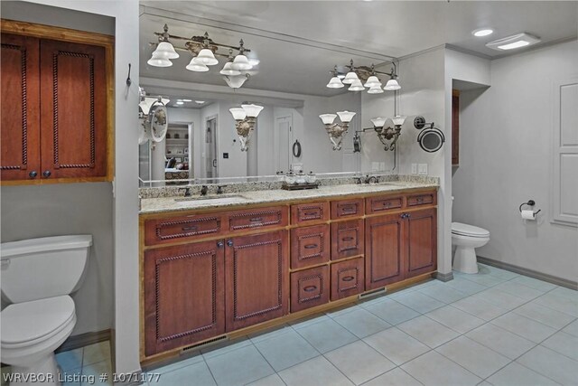 bathroom featuring vanity, tile patterned floors, and toilet