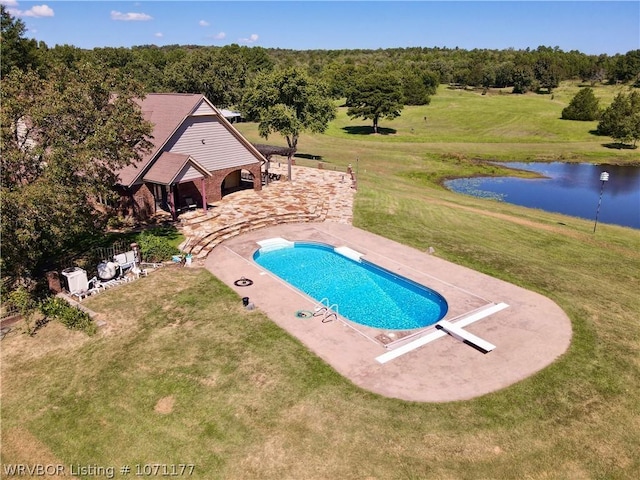 view of swimming pool featuring a water view, a diving board, a patio area, and a lawn