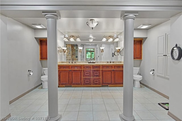 bathroom featuring decorative columns, tile patterned floors, and toilet