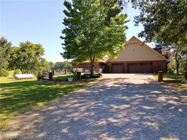 view of front of home with a garage and a front yard