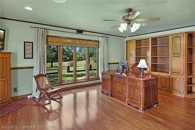 office area with ceiling fan, ornamental molding, and light wood-type flooring