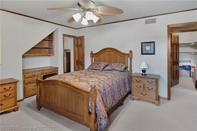 bedroom featuring crown molding, light carpet, and ceiling fan