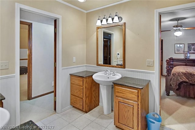 bathroom with tile patterned flooring, ornamental molding, and ceiling fan