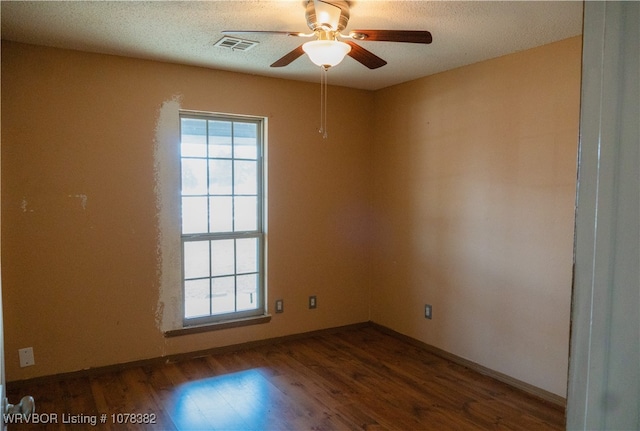 empty room with a textured ceiling, ceiling fan, and hardwood / wood-style floors