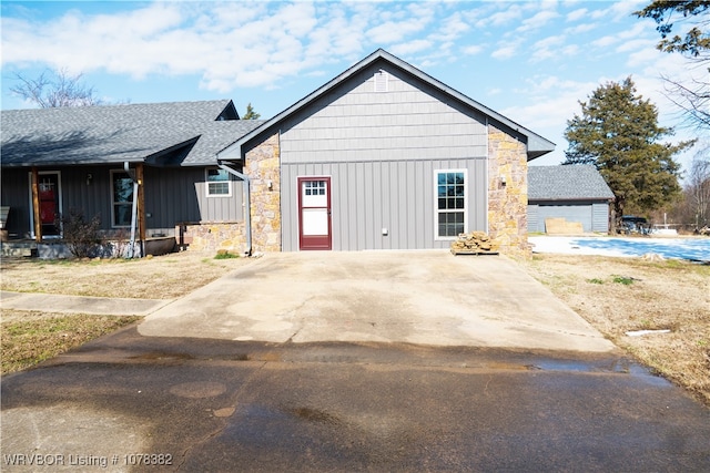 view of side of home with an outbuilding, covered porch, and a garage