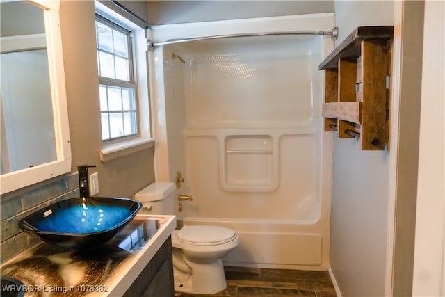 full bathroom featuring toilet, vanity, hardwood / wood-style flooring, and  shower combination