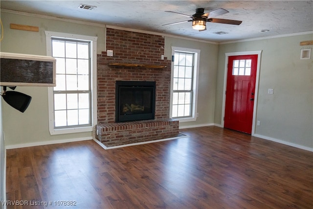 unfurnished living room featuring ceiling fan, ornamental molding, and a fireplace