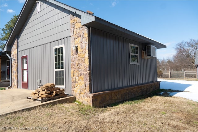 view of side of home with a yard and a patio