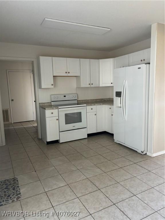 kitchen featuring white cabinets, white appliances, and light tile patterned floors