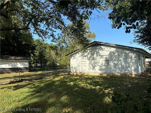 view of side of home featuring a lawn