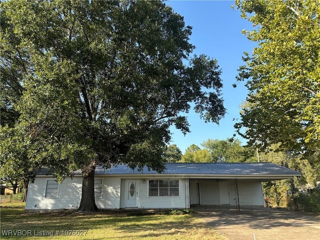 ranch-style house with a front yard and a carport