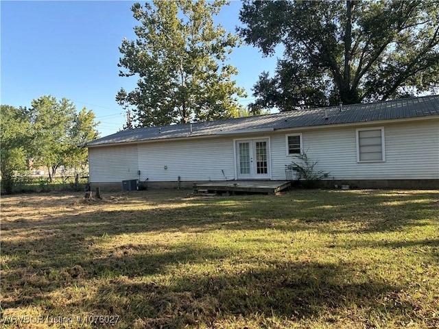 back of house featuring french doors, a deck, cooling unit, and a lawn