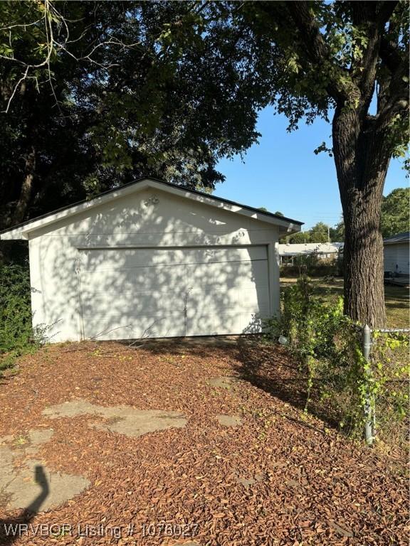 view of home's exterior with an outbuilding and a garage