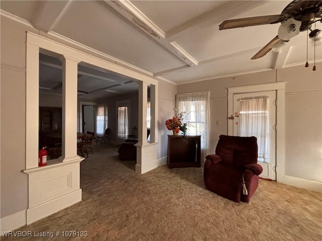 unfurnished living room with carpet, a ceiling fan, and ornate columns