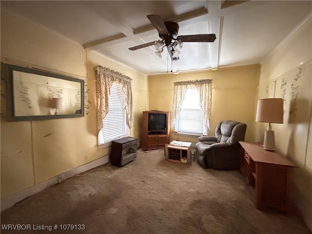 sitting room featuring carpet floors, ceiling fan, ornamental molding, and beam ceiling