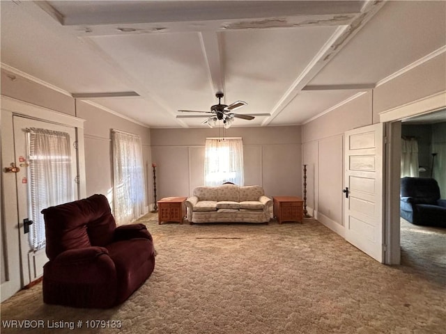 carpeted living room featuring beam ceiling, a decorative wall, and ceiling fan