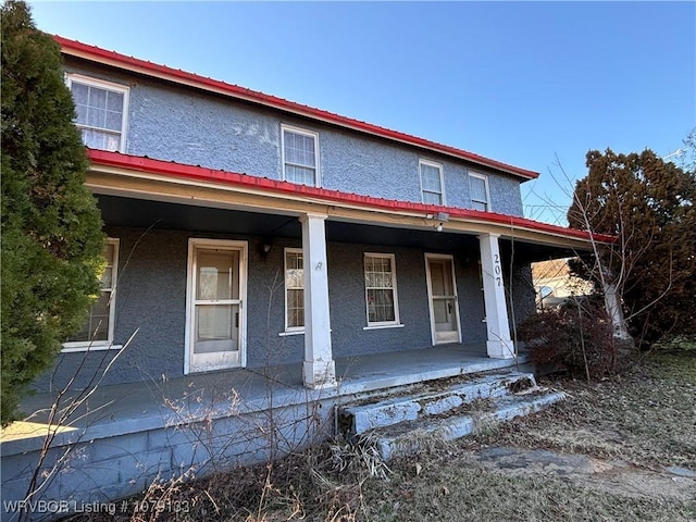 view of front of home with a porch and stucco siding