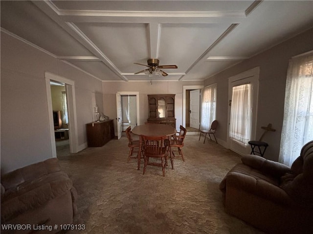 carpeted dining area featuring a ceiling fan, beam ceiling, a healthy amount of sunlight, and coffered ceiling