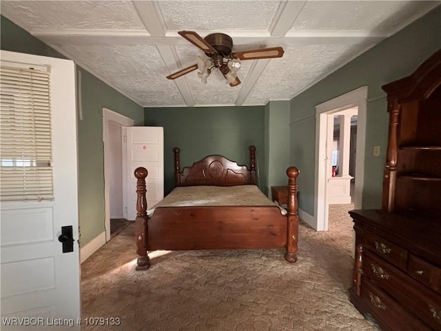 carpeted bedroom featuring ceiling fan, a textured ceiling, and baseboards