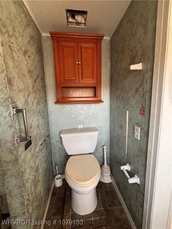 bathroom with toilet and tile patterned floors