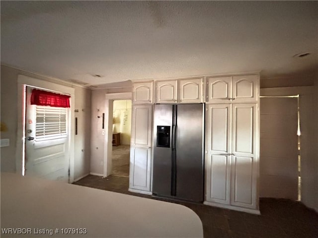 kitchen with light countertops, white cabinets, and stainless steel refrigerator with ice dispenser