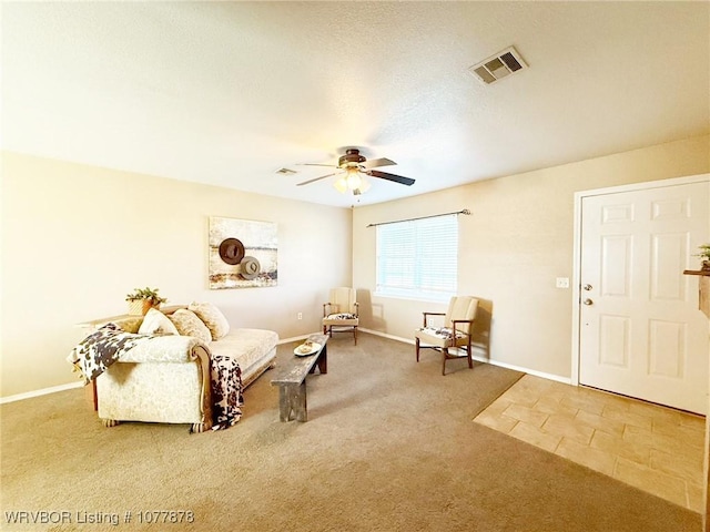 living room featuring carpet and ceiling fan