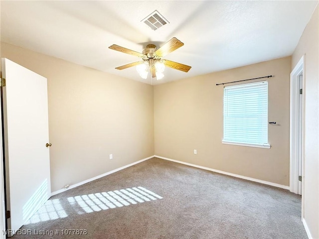 carpeted spare room featuring ceiling fan