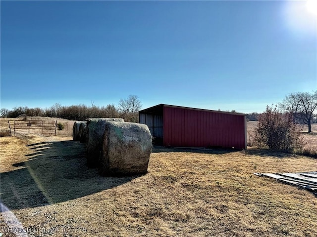 view of yard featuring an outbuilding and a rural view