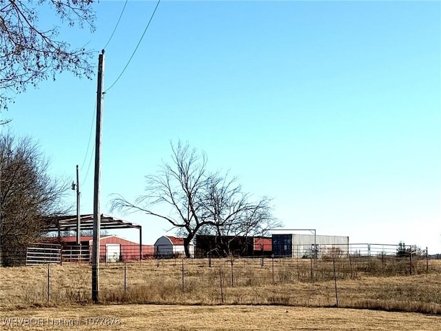 view of yard featuring an outbuilding and a rural view