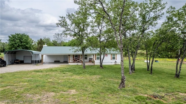 473413 E 1050th Rd, Muldrow, OK 74948 - single story home featuring covered porch, driveway, metal roof, a detached carport, and a front lawn