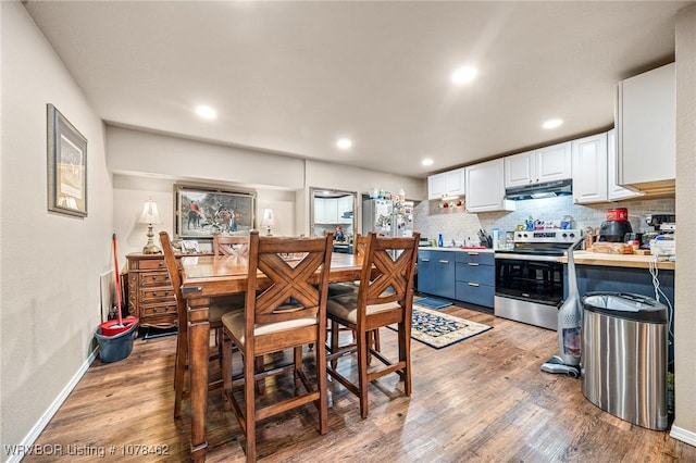 kitchen with light wood-type flooring, white cabinetry, blue cabinets, and stainless steel electric stove