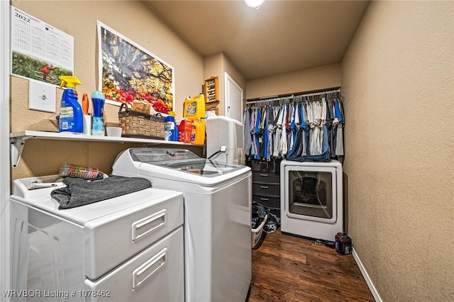 clothes washing area featuring dark hardwood / wood-style floors and washing machine and dryer