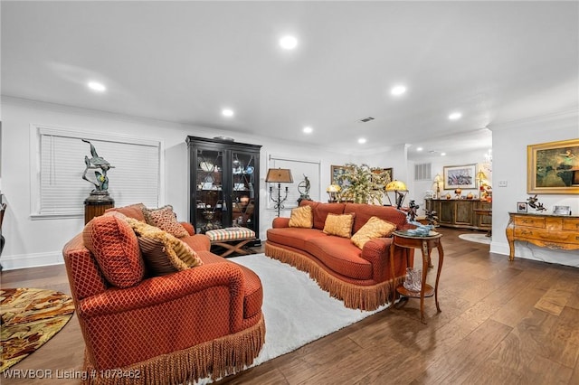 living room with dark hardwood / wood-style floors and ornamental molding