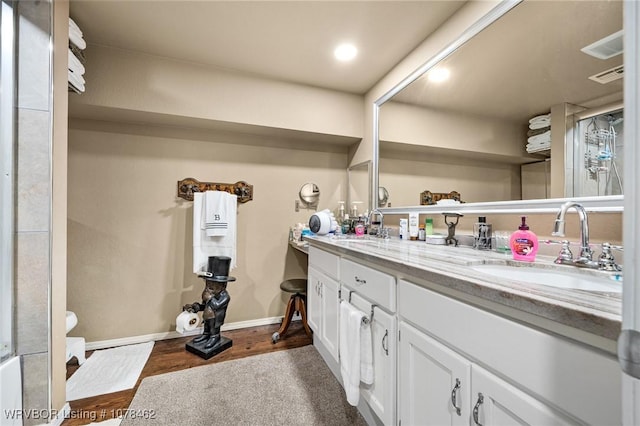 bathroom with hardwood / wood-style floors and vanity