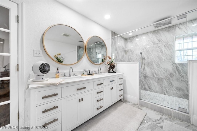 bathroom featuring an enclosed shower and vanity