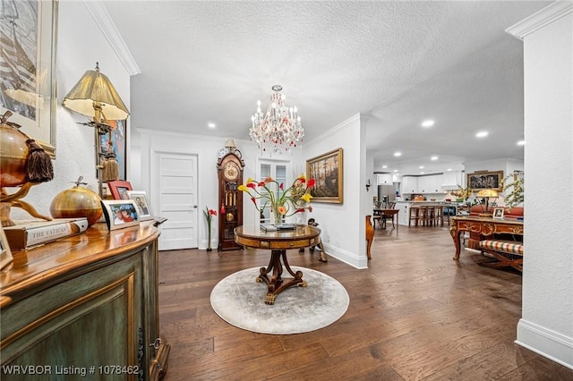 entrance foyer featuring dark wood-type flooring, crown molding, and a textured ceiling