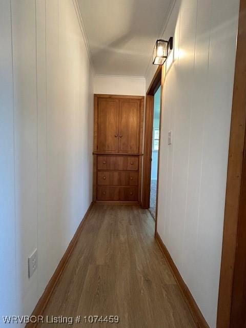 hall featuring wood-type flooring and ornamental molding