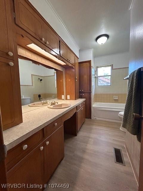 bathroom featuring vanity, toilet, and ornamental molding