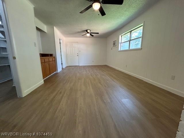 interior space featuring dark hardwood / wood-style flooring and a textured ceiling