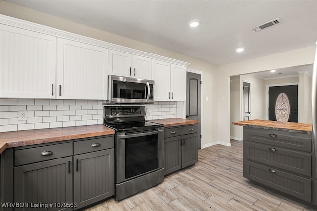 kitchen with visible vents, gray cabinetry, butcher block countertops, appliances with stainless steel finishes, and white cabinets