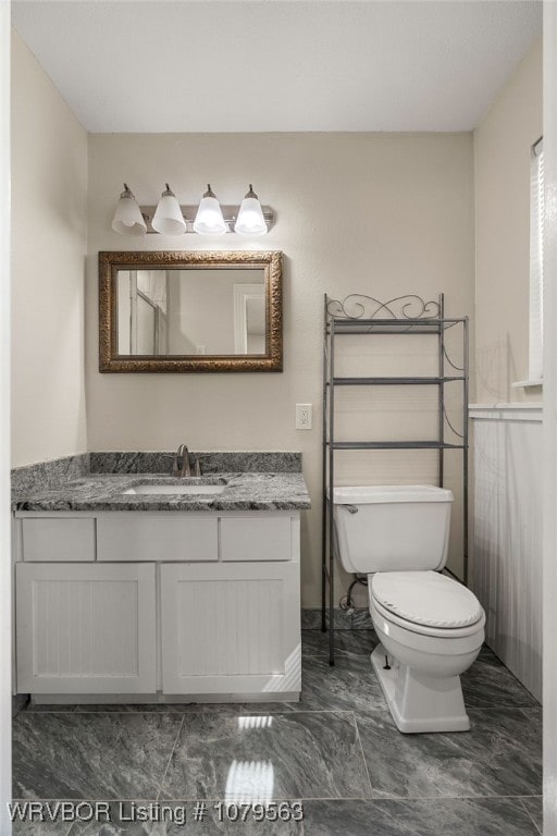 bathroom with toilet and vanity