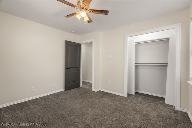 unfurnished bedroom featuring baseboards, dark colored carpet, a closet, and ceiling fan