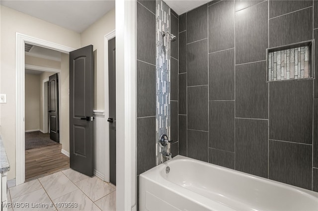 full bathroom with washtub / shower combination and baseboards