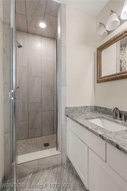 full bathroom with a stall shower and vanity